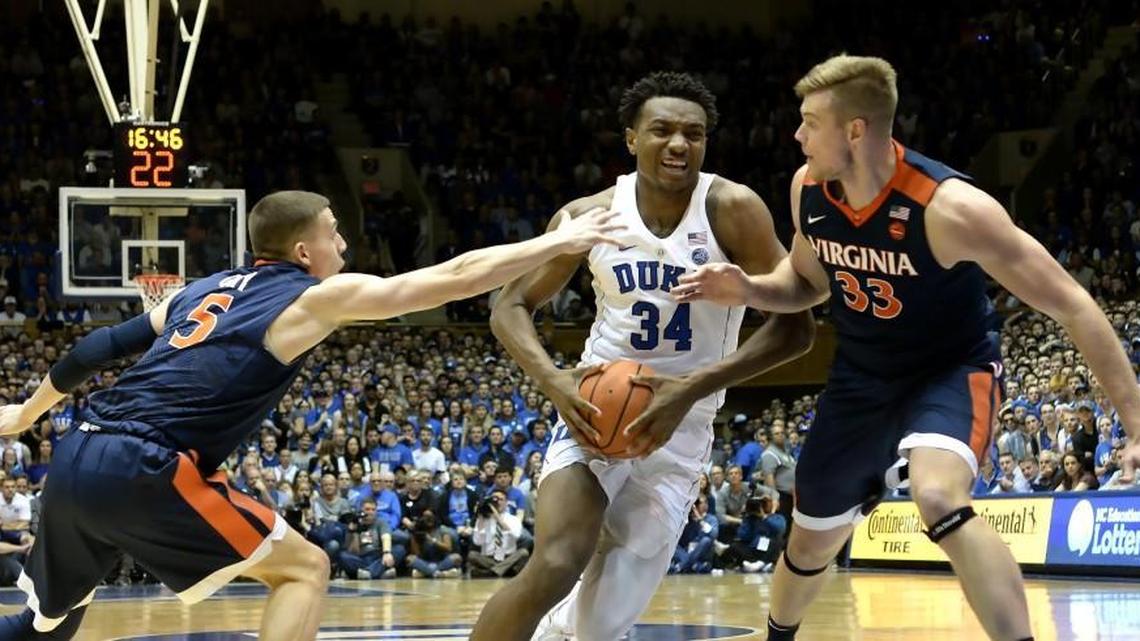 Duke forward Wendell Carter Jr (34) attempyts to break towards the basket as Virginia guard Kyle Guy (5) and center Jack Salt (33) defend in the first half. Duke battled Virginia at Cameron Indoor Stadium In Durham, N.C., Saturday, Jan. 27, 2018