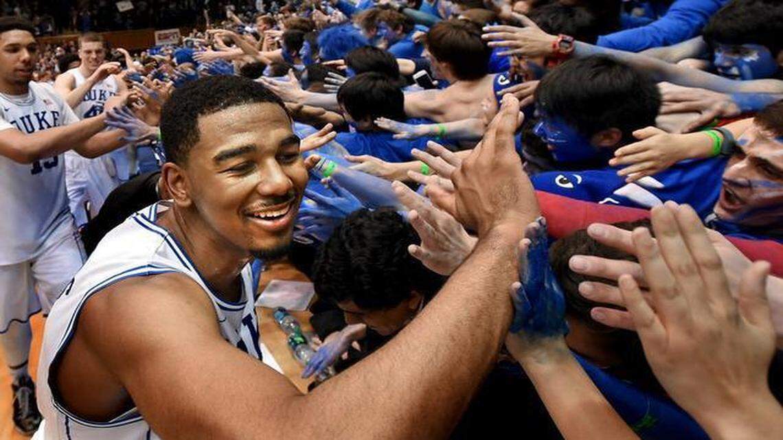 
Duke guard Matt Jones (13) and teammates center Jahlil Okafor (15) and center Marshall Plumlee (40) react with fans as they beat North Carolina 92-90 in overtime in Durham, NC Wednesday, Feb. 18, 2015.
