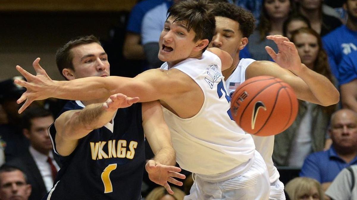 Duke's Grayson Allen (3) attempts to disrupt a pass by Augustana'a Austin Saugstad (1) during the first half at Cameron Indoor Stadium.