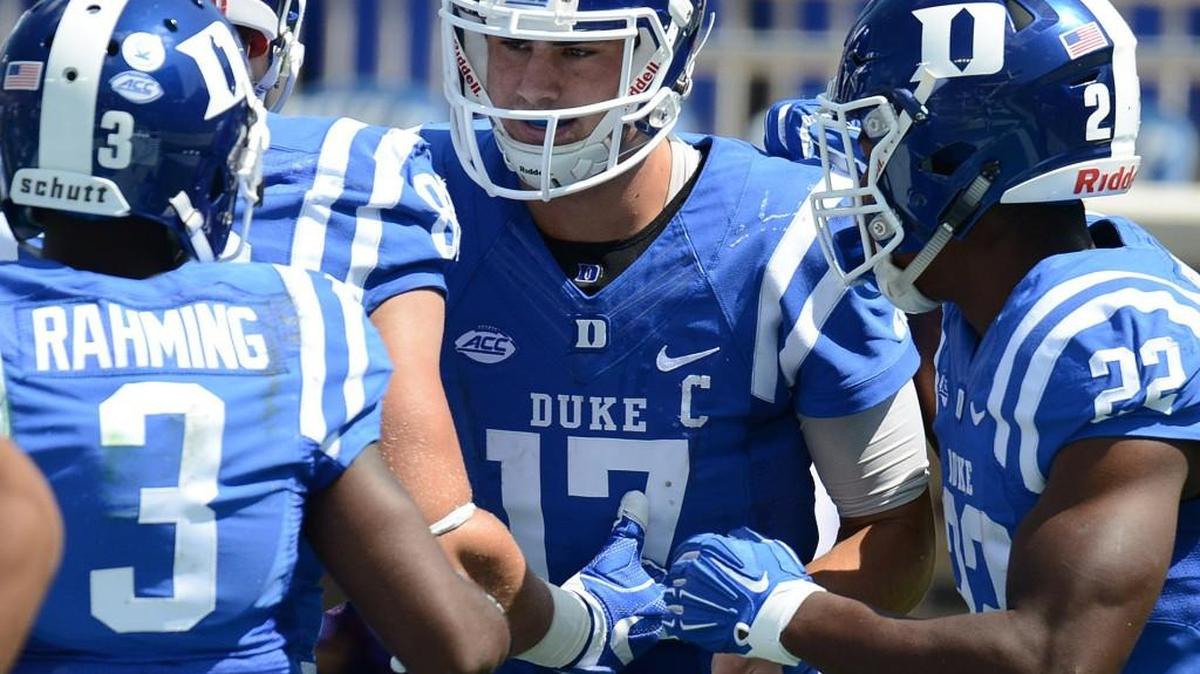 Duke quarterback Daniel Jones, middle, talks to T.J. Rahming, left, and Brittain Brown, right, during the Blue Devils’ game against Northwestern.