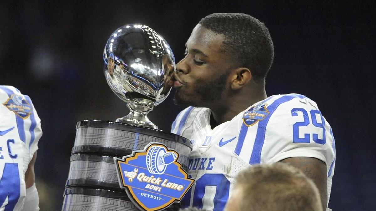 Duke running back Shaun Wilson kisses the championship trophy after defeating Northern Illinois 36-14 in the Quick Lane Bowl on Dec. 26.
