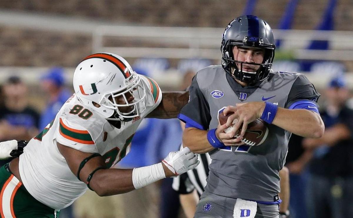 Miami's RJ McIntosh, left, chases Duke quarterback Daniel Jones in September.
