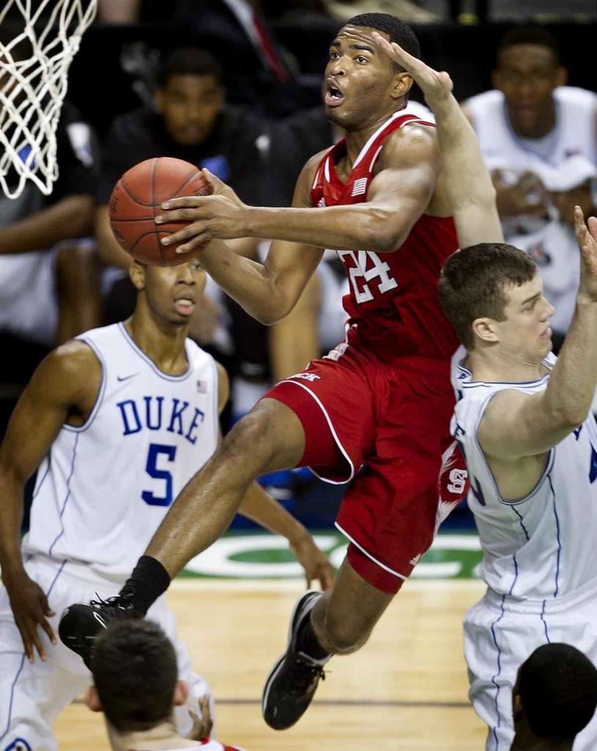 N.C. State’s T.J. Warren, middle, drives to the basket between Duke’s Marshall Plumlee, right, and Rodney Hood, left, in 2014.