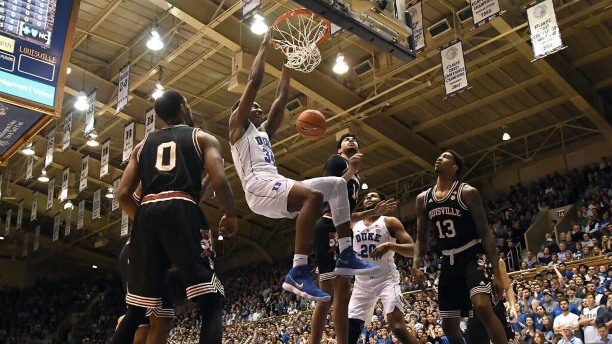 Duke forward Wendell Carter Jr. (34) jams home a dunk over the Louisville defense in the first half of play. Duke battled Louisville at Cameron Indoor Stadium in Durham on Wednesday, Feb. 21, 2018.