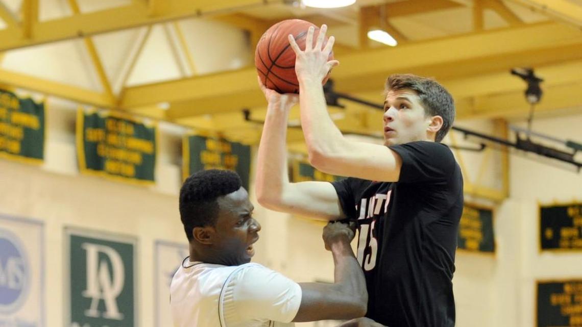 Trinity’s Joey Baker, right, shoots over Cape Fear Christian’s Henry Odunze during the NCISAA 1A boys championship basketball game in 2016.