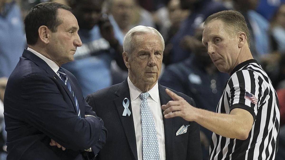 Official Mike Eades, right, is hanging up his whistle to supervise referees in the SEC.