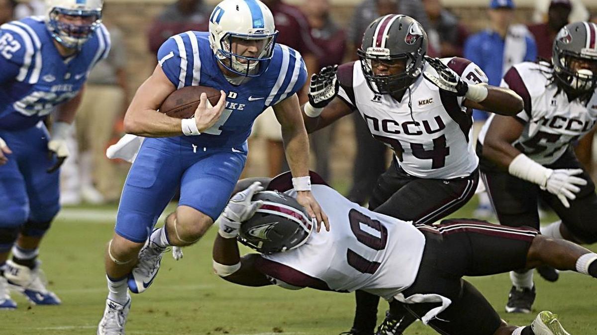 Duke quarterback Thomas Sirk heads for the end zone against N.C. Central’s Jordan Miles, 10, and Kenneth O’Neal, 34, on Sept. 12. Sirk and the rest of the Blue Devils’ offense need to be full speed Saturday against Indiana in the Pinstripe Bowl.