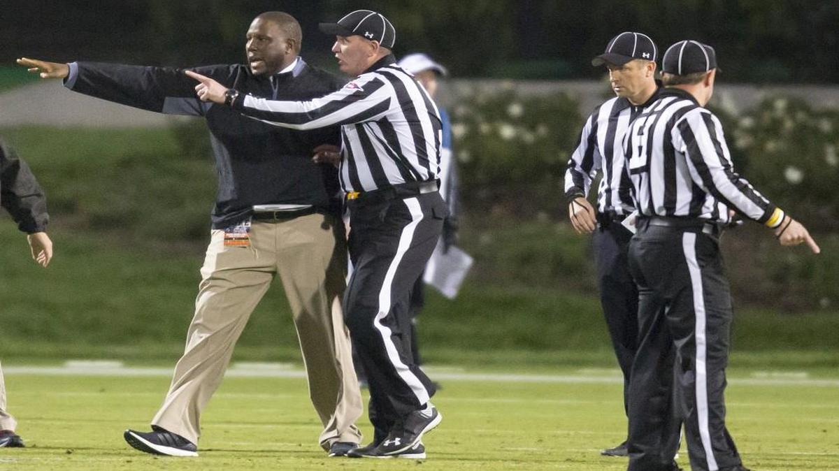 Miami interim head coach Larry Scott speaks with Center Judge Tracy Lynch following a controversial kickoff return, with eight laterals, that ended in a touchdown to end the game and give Miami the win, 30-27, over Duke. A penalty for a block in the back was called during the play, and one player appeared to be down before a lateral, but the play was allowed to stand as a touchdown. On Sunday, Nov. 1, 2015, the ACC announced that the officiating and replay crew has been suspended for two games for mistakes made during the play.