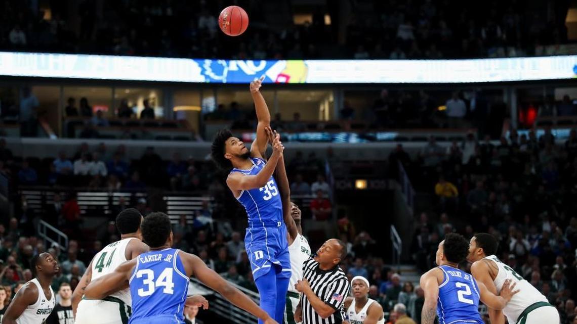 Duke forward Marvin Bagley III, middle in blue, gets possession of the ball over Michigan State forward Jaren Jackson Jr. during tipoff of the game on Nov. 14. Duke won, 88-81.
