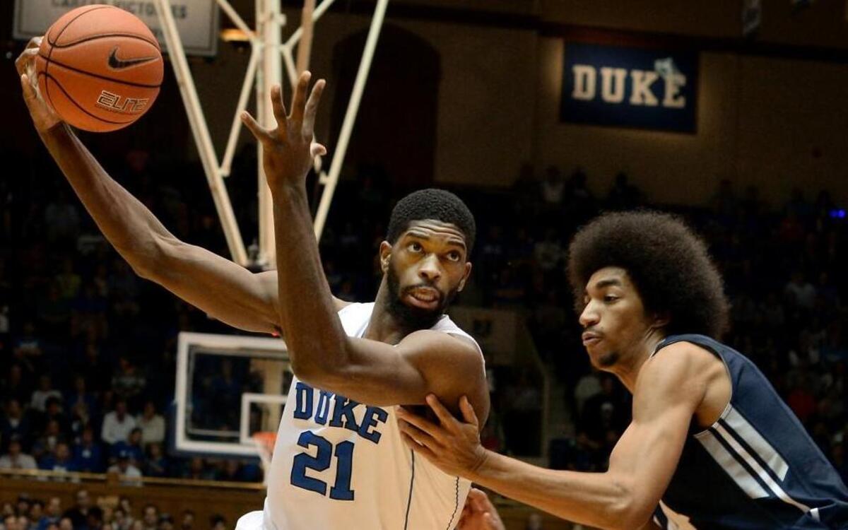 Duke forward Amile Jefferson (21) moves the ball past Utah State forward Jalen Moore (14) in the first half of play as he heads towards the basket. Duke defeated Utah State 85-52 at Cameron Indoor Stadium, Sunday, November 29, 2015 in Durham, N.C.