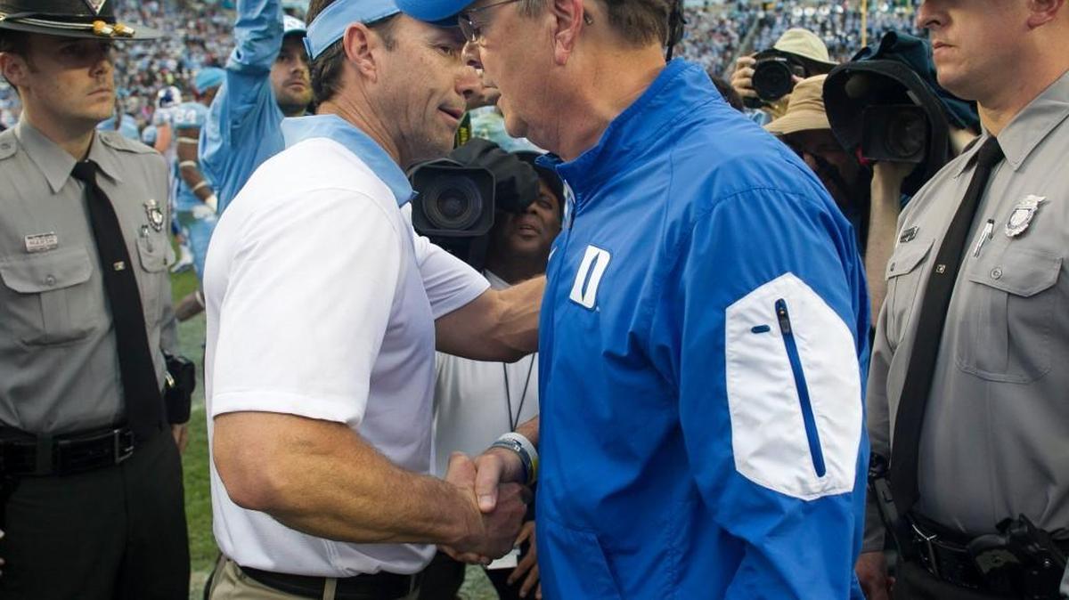 Duke coach David Cutcliffe congratulates North Carolina coach Larry Fedora following the Tar Heels’ 66-31 victory over Duke on Nov. 7, 2015 at Kenan Stadium in Chapel Hill.
