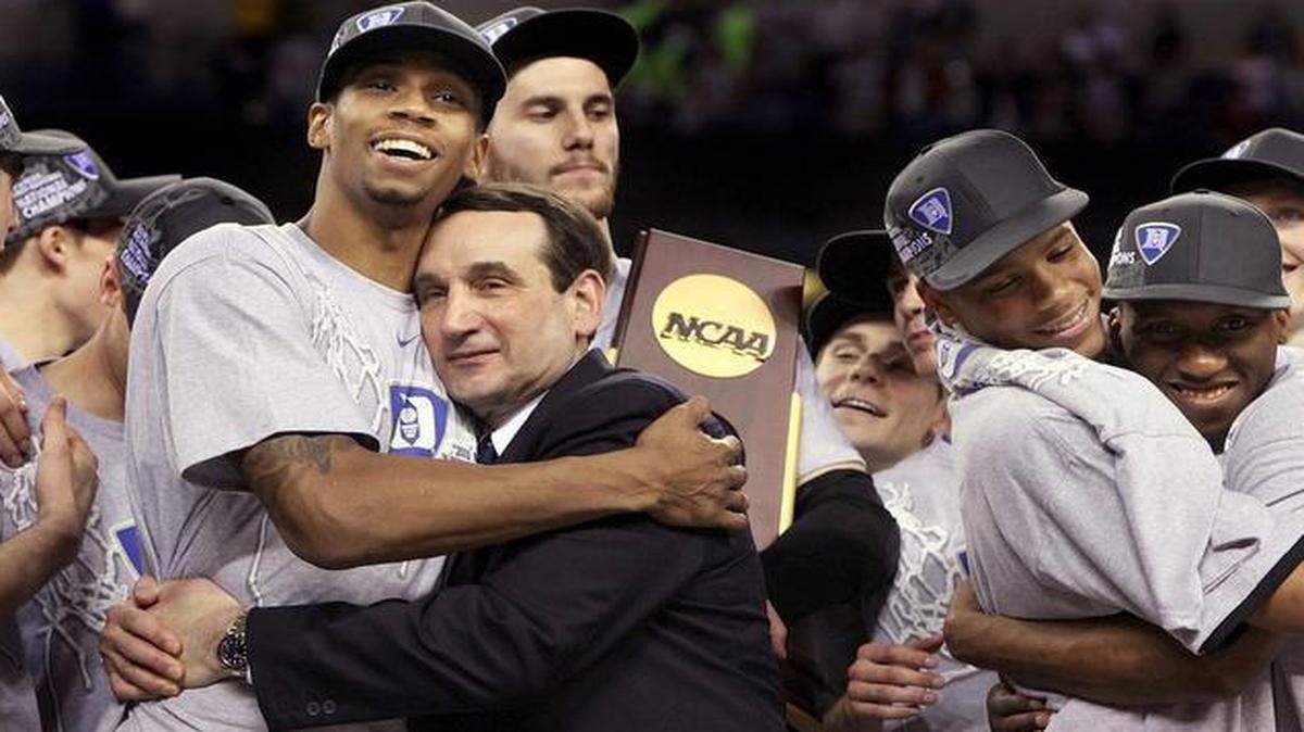 
Duke coach Mike Krzyzewski hugs senior forward Lance Thomas while Brian Zoubek clutches the school’s fourth NCAA championship trophy after the 2010 title game. 
