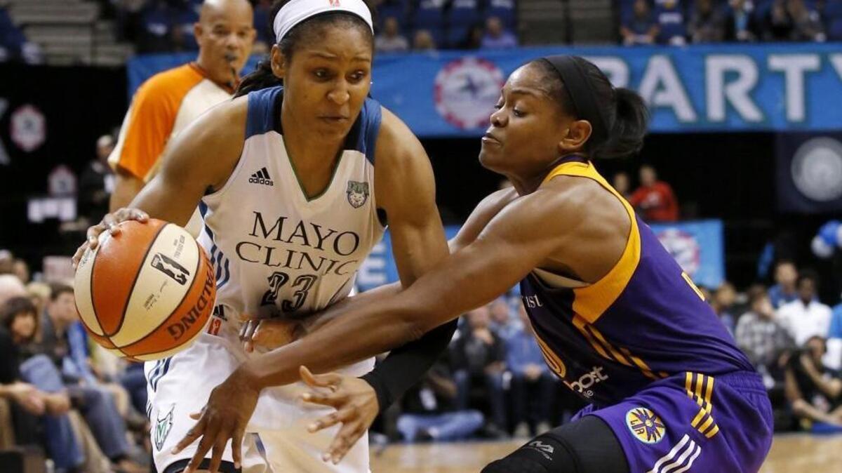 Minnesota Lynx forward Maya Moore, left, drives against Los Angeles Sparks guard Alana Beard in Game 1 of the WNBA Western Conference semifinals in 2015.