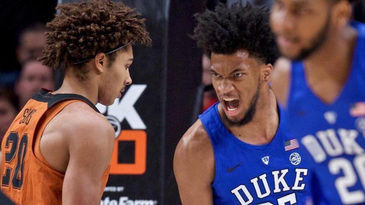 Duke forward Marvin Bailey III, right, reacts after dunking over Texas forward Jericho Sims during the first half of an NCAA college basketball game in the Phil Knight Invitational tournament in Portland, Ore., Friday, Nov. 24, 2017.