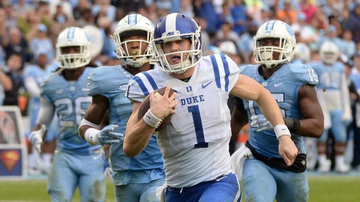 Duke quarterback Thomas Sirk (1) betas the UNC defense in a footrace to score in the second half of play against the Tar Heels. UNC defeated Duke 66-31 at Kenan Stadium in Chapel Hill, N.C. Saturday, November 7, 2015.