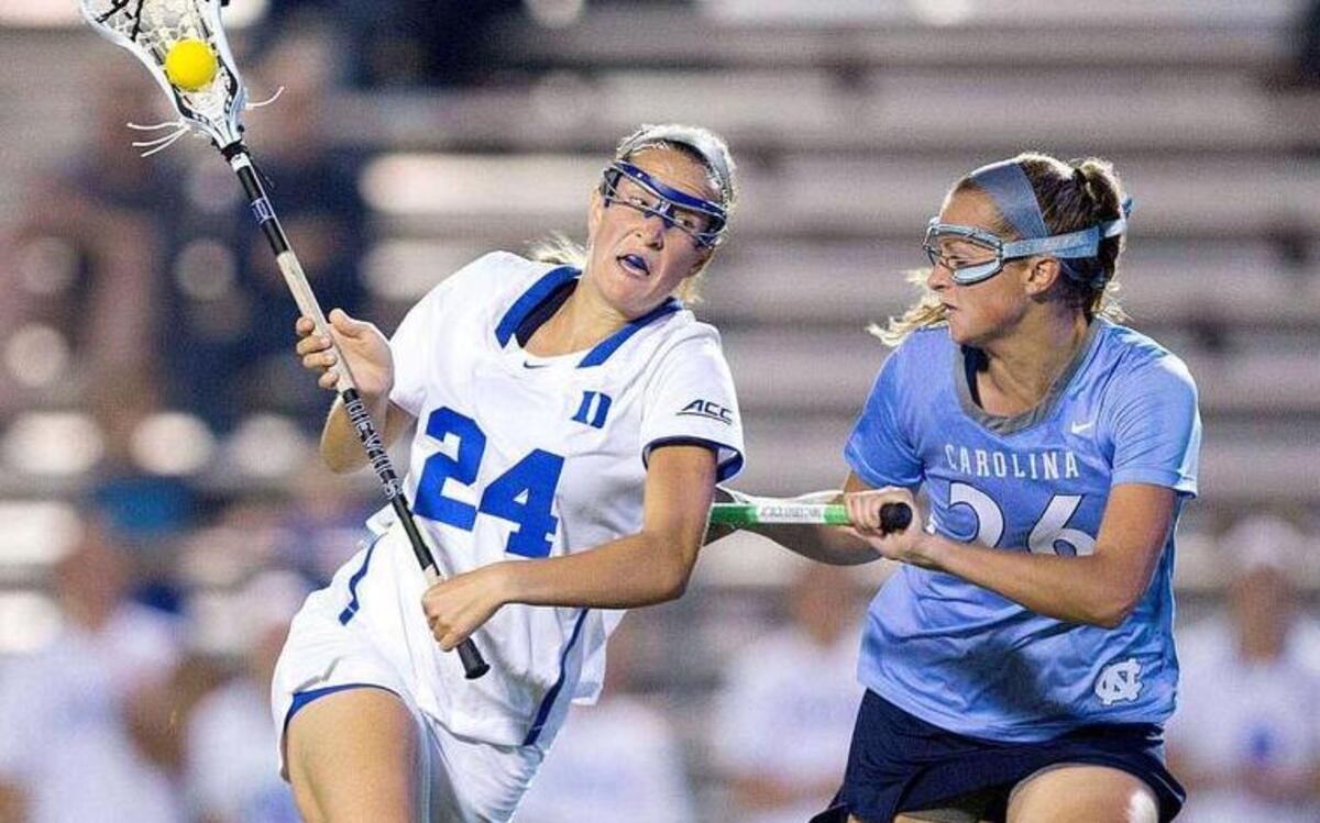 
Duke's Katie Trees (24), left, controls the ball as she is challenged by North Carolina's Kelly Devlin (26) during their game at Koskinen Stadium in Durham on April 17, 2015.
