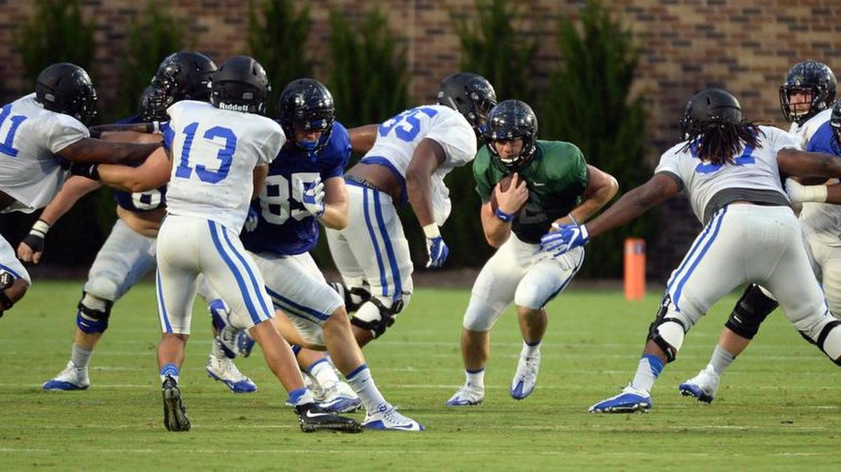 The Duke defensive unit converges on quarterback Parker Boehme on Brooks Field at Wallace Wade Stadium in Durham, N.C. Friday, August 19, 2016 during an intrasquad scrimmage.