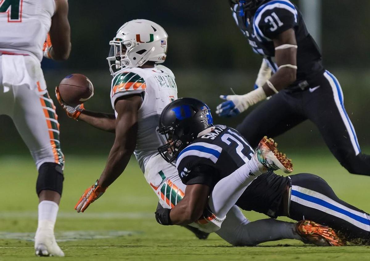 Miami running back Mark Walton appears to be down as he’s tackled by Duke cornerback Alonzo Saxton II in the closing seconds of the game on Oct. 31, 2015. Missed calls in the last play of the game, which included eight laterals, led to the officiating crew being suspended by the ACC.