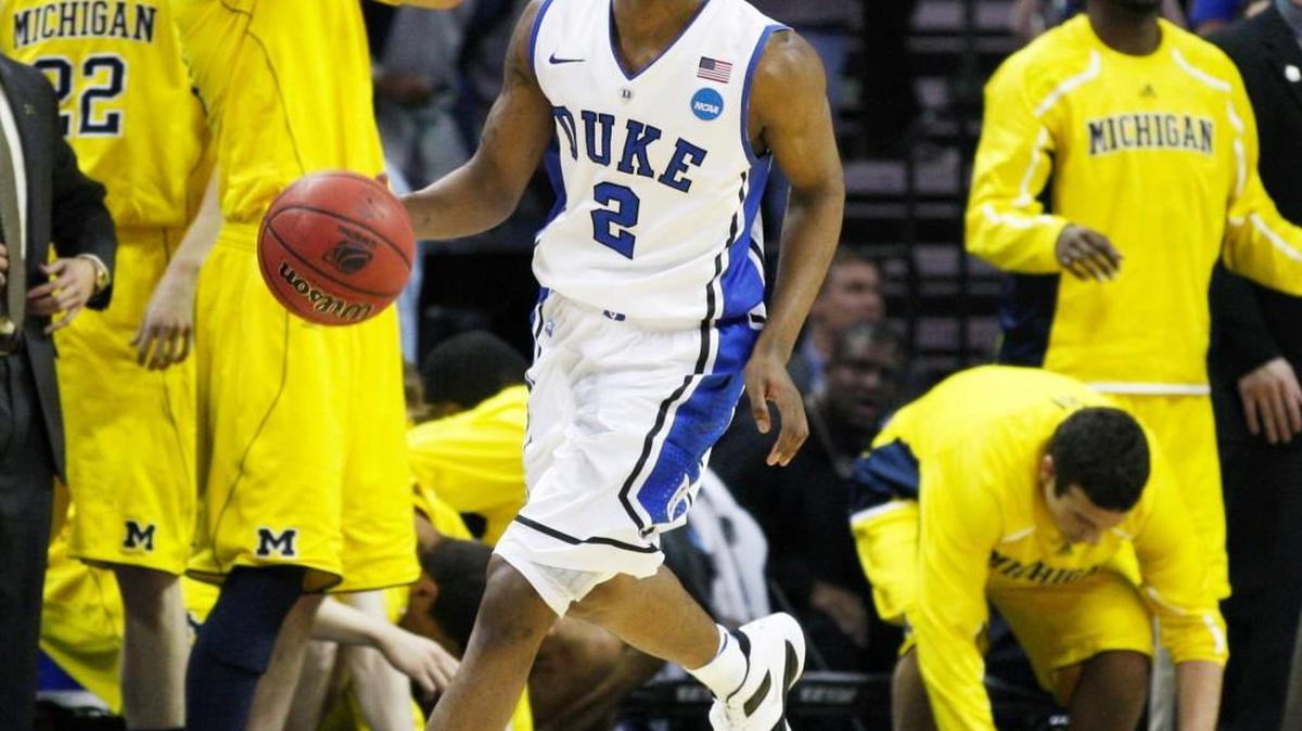 Duke’s Nolan Smith smiles as the buzzer sounds and he runs past the Michigan bench at Time Warner Cable Arena in 2011.