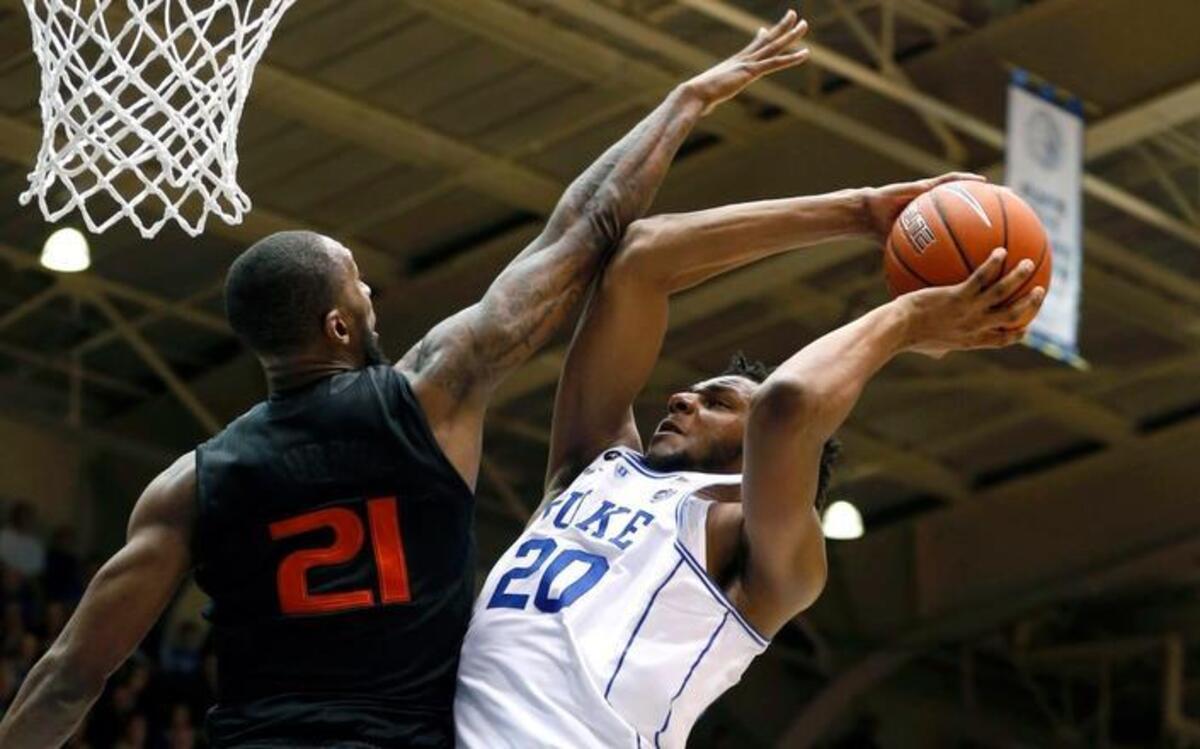 Duke’s Marques Bolden, right, shoots as Miami’s Kamari Murphy, left, defends during the Blue Devils’ 70-58 win over the Hurricanes on Jan. 21.