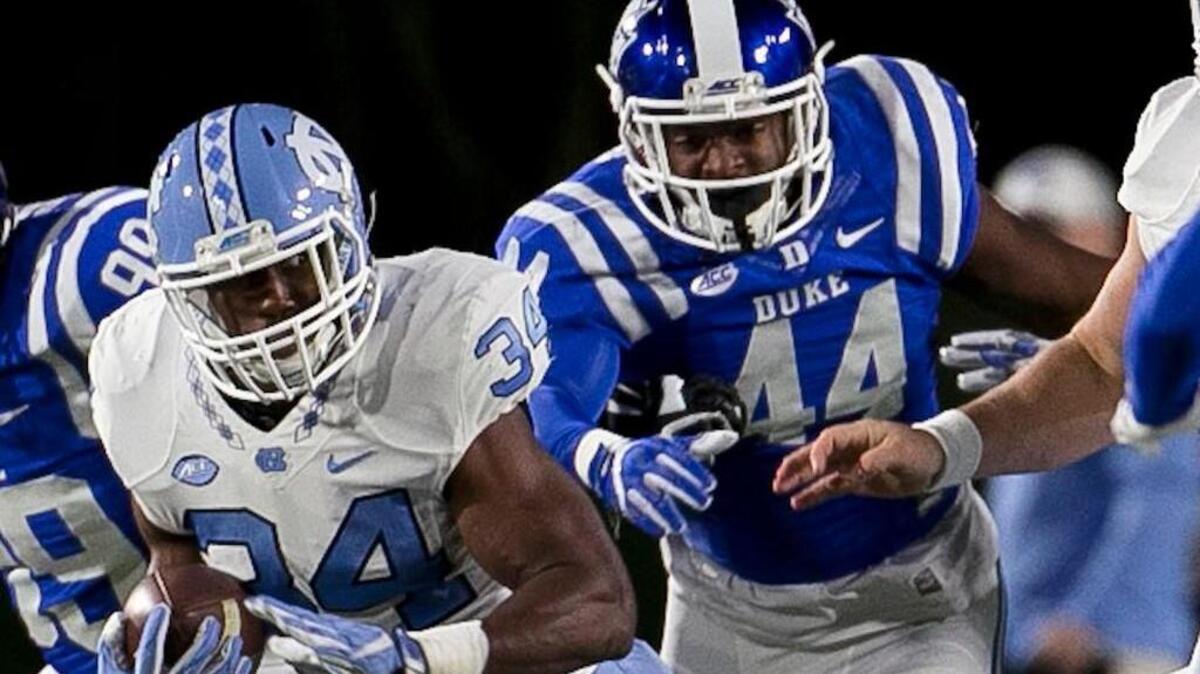 North Carolinas Elijah Hood (34) breaks open for a 20 yard gain ahead of Dukes Joe Giles-Harris (44) in the first quarter on Thursday, November 10, 2016 at Wallace Wade Stadium in Durham, N.C.