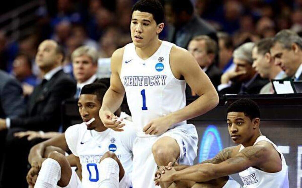 
Marcus Lee (0)  Devin Booker (1)  and Tyler Ulis (3)  of the Kentucky Wildcats wait at the scorer’s table to enter the game against the Notre Dame Fighting Irish in the first half during the Midwest Regional Final of the 2015 NCAA Men’s Basketball tournament at Quicken Loans Arena  in Cleveland, Ohio.
