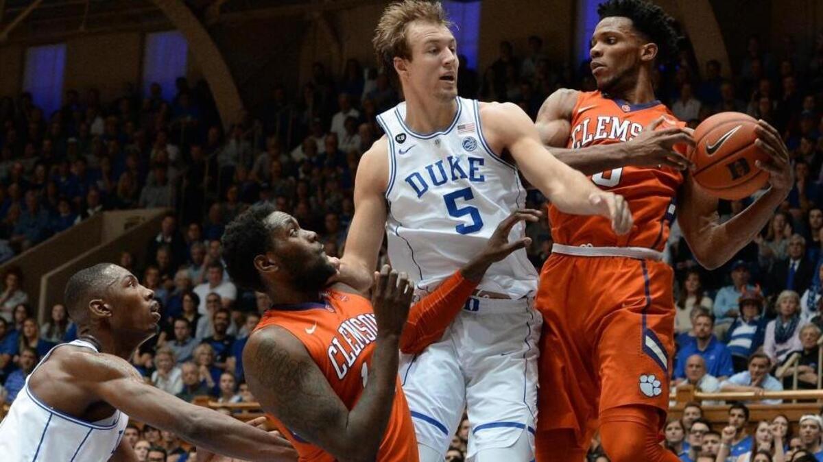 Duke guard Luke Kennard (5) and Clemson forward Jaron Blossomgame (5) battle for a rebound in the Blue Devils’ 64-62 win over the Tigers on Feb. 11.