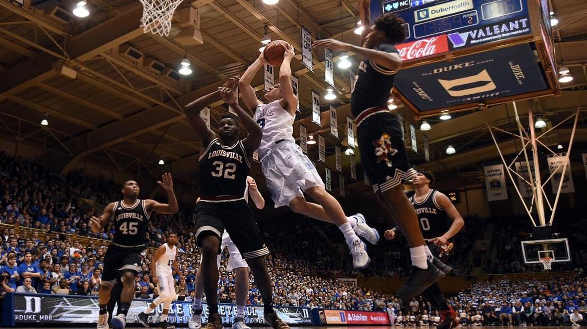 Duke guard Grayson Allen goes in to score as Louisville center Chinanu Onuaku defends in the Blue Devils’ 72-65 win on Feb. 8. Allen led the team with 19 points.