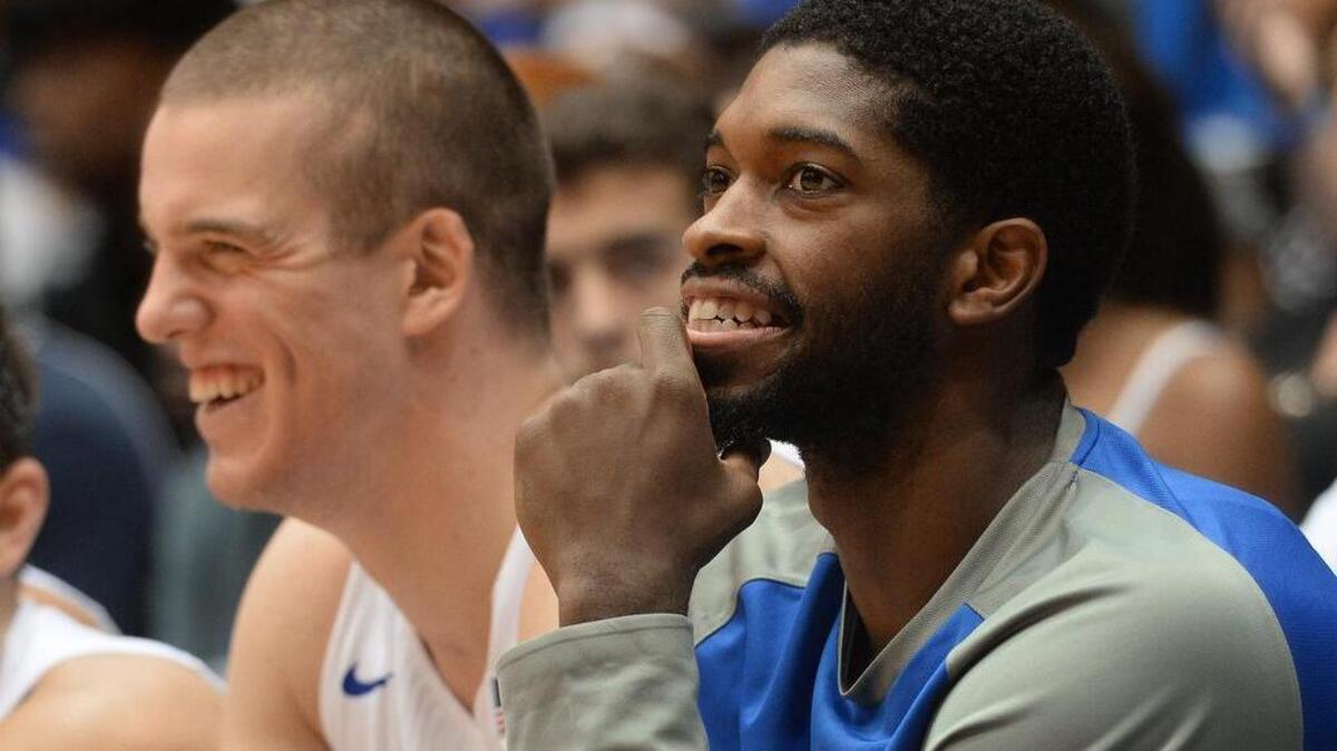 Duke's Amile Jefferson, right, laughs with teammate Marshall Plumlee on the bench in the second half of the Blue Devils’ 119-54 win over Livingstone on Nov. 4. Jefferson sprained his ankle during the first half.