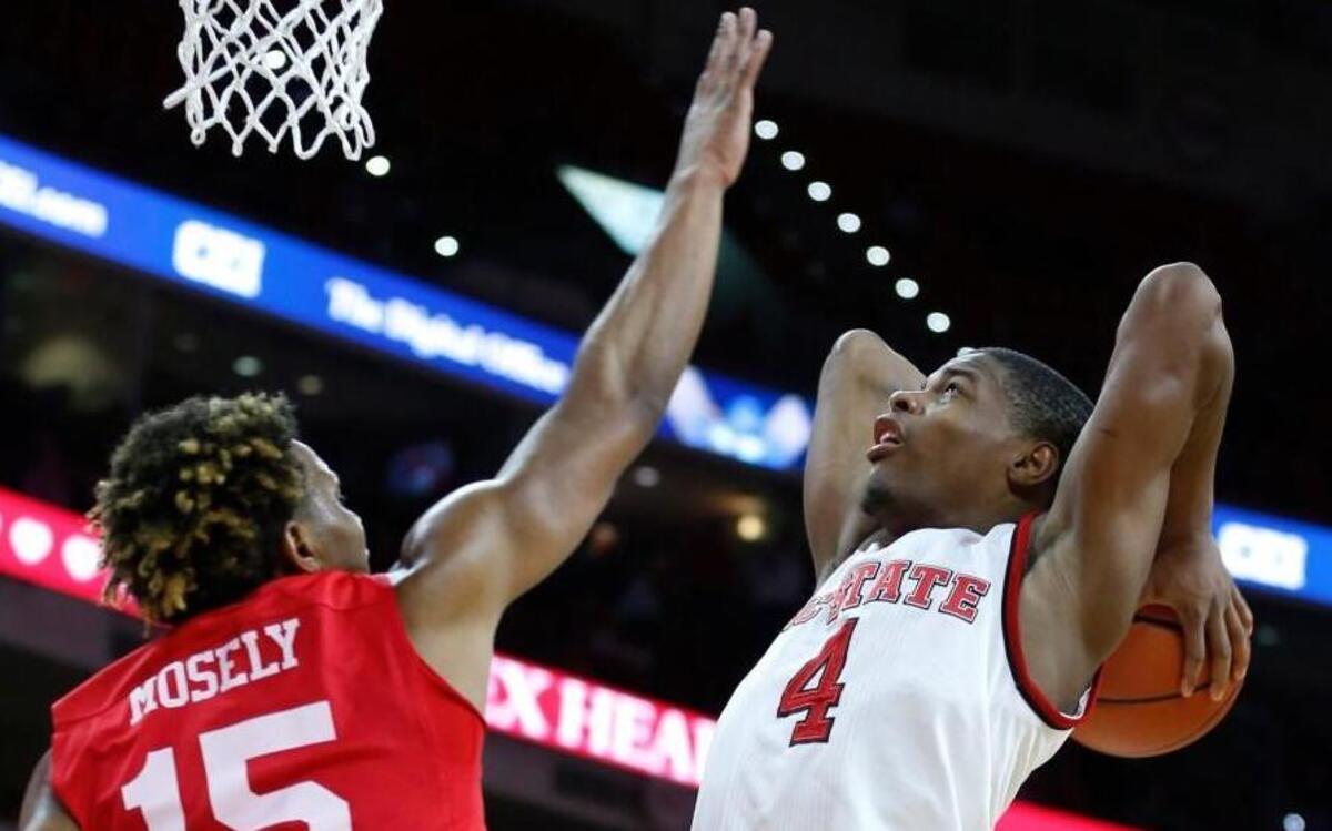 N.C. State's Dennis Smith Jr. (4) heads to slam in two as Boston University's Cheddi Mosely (15) defends in the second half during N.C. State's 77-73 victory over Boston University at PNC Arena in Raleigh, N.C., Saturday, Dec. 3, 2016.