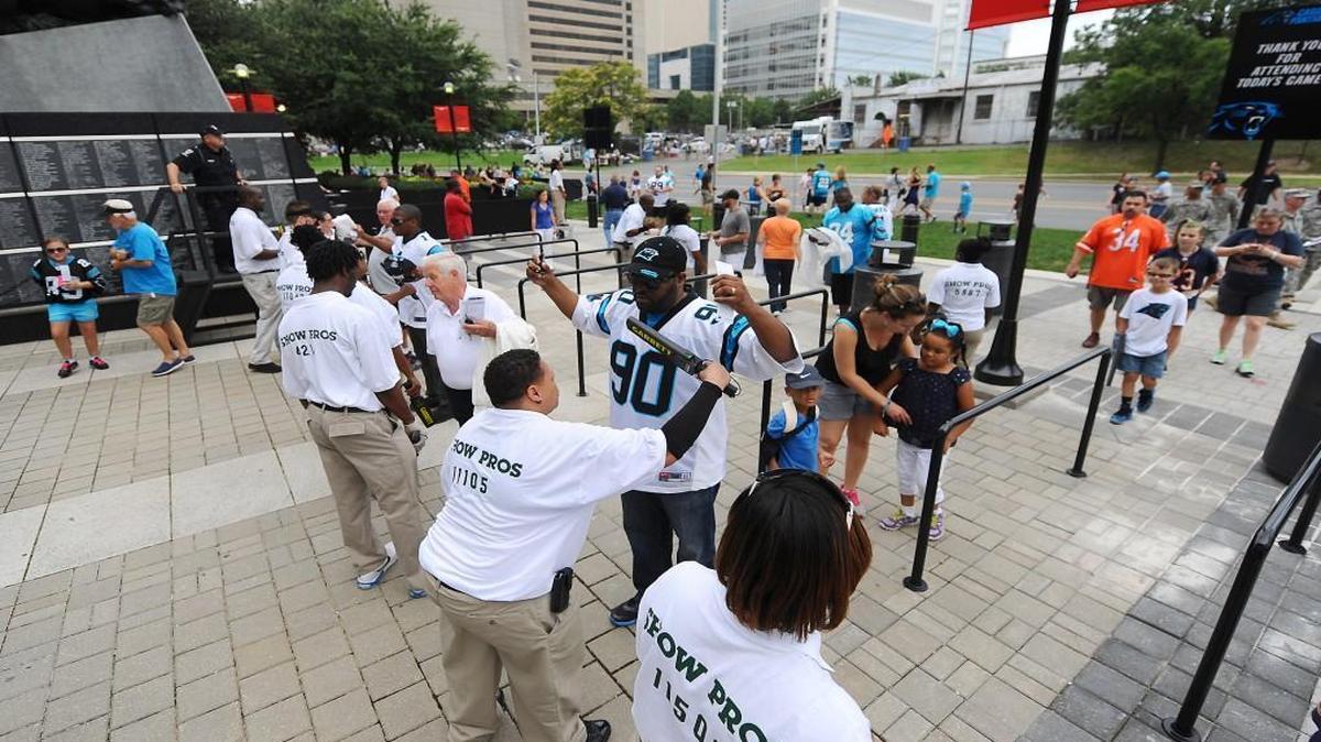Event staff employees scan fans as they enter Bank of America Stadium prior to a Carolina Panthers preseason game against the Chicago Bears in August 2013. The ACC announced Friday that security measures for the 2015 ACC Championship Game at the stadium will mirror those taken for Panthers games.