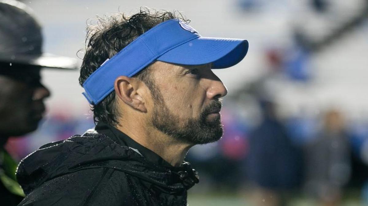 North Carolina coach Larry Fedora stands behind his players during the playing of the alma mater following the Tar Heels 34-3 loss to Virginia Tech last Saturday at Kenan Stadium.