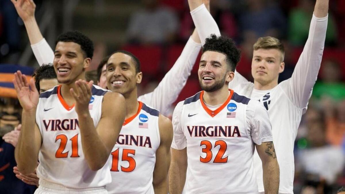 Virginias Isaiah Wilkins (21), Malcolm Brogdon (15), and London Perrantes (32) react after a three point basket during the Cavaliers’ 81-45 win over Hampton in the first round of the NCAA Tournament Thursday in Raleigh.