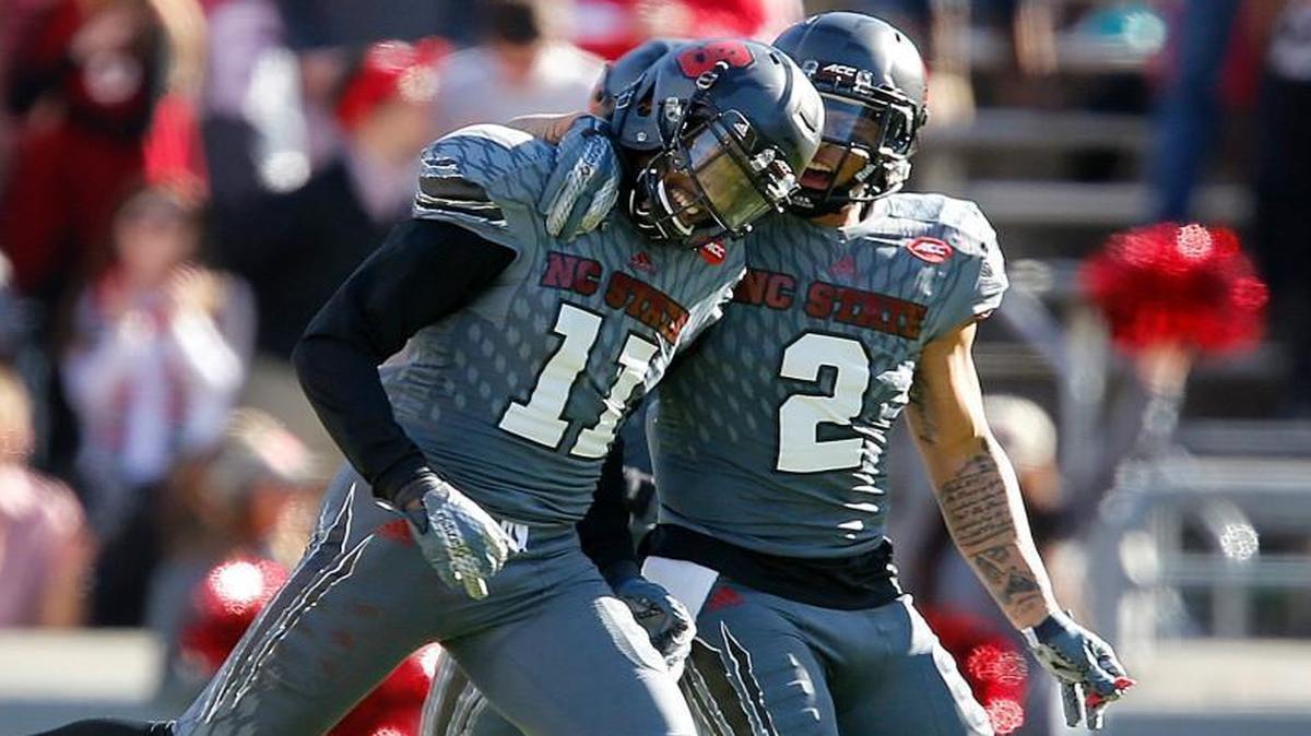 N.C. State's Josh Jones (2) celebrates with Juston Burris (11) after Burris stopped a 2-pt conversion by Syracuse during the Wolfpack's game against Syracuse at Carter-Finley Stadium in Raleigh, N.C., Saturday, Nov. 21, 2015.