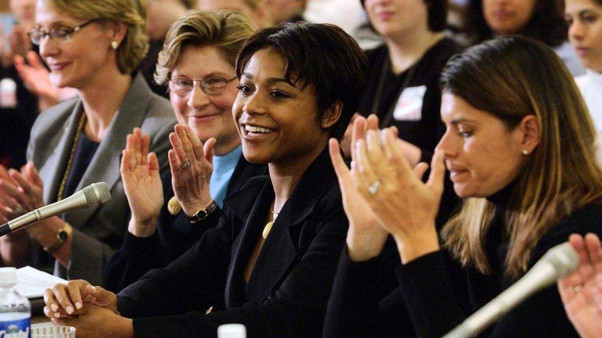 Fellow witnesses applaud Olympic gymnast Dominique Dawes, center, as she is introduced at a hearing on Title IX, the women's educational equity law on April 7, 2003 in Washington, D.C. Left to right are Nancy Hogshead-Makar, Olympic swimmer and professor at the Florida Coastal School of Law; Marnie Shaul, a Government Accounting Office official; Dawes, and World Cup soccer champion Mia Hamm. Title IX governs equity in women's sports. (AP Photo/Gerald Herbert)