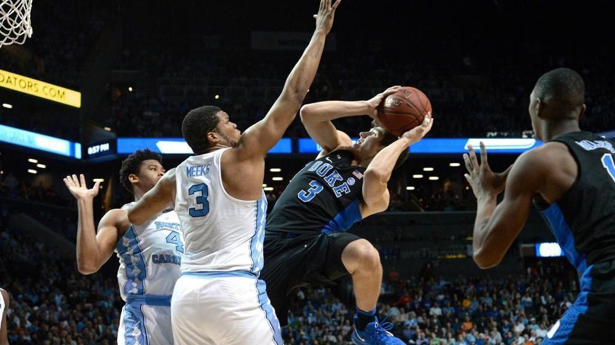 UNC forward Kennedy Meeks (3) attempts to block Duke guard Grayson Allen’s shot during the ACC tournament last March.