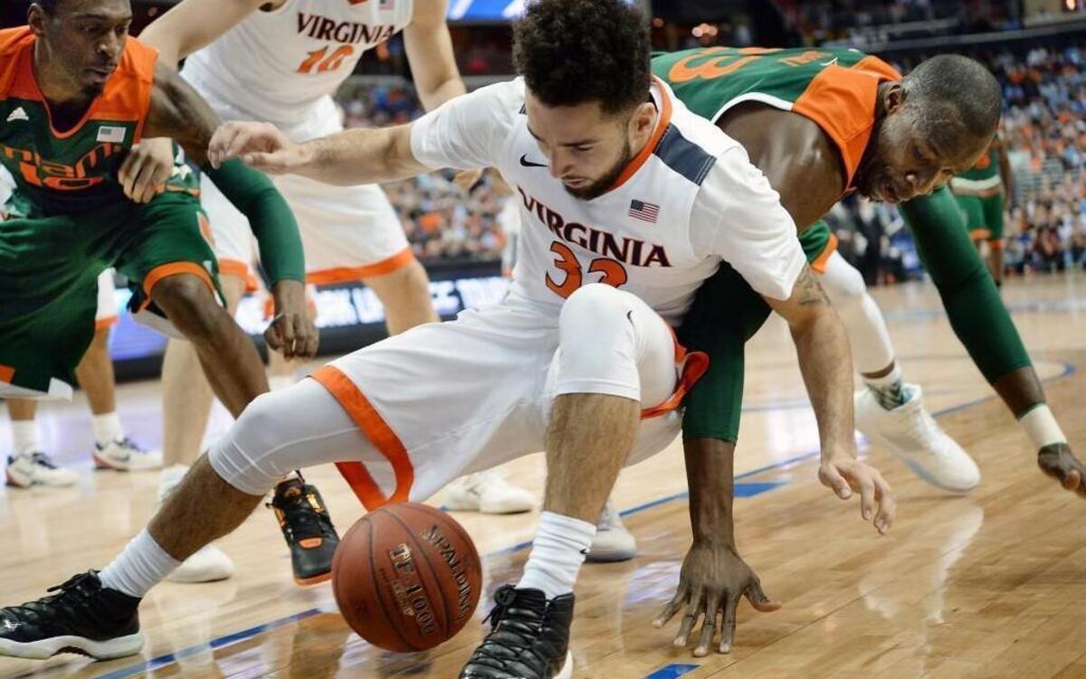 Miami’s Sheldon McClellan (10) and Tonye Jekiri (23) cause Virginia’s London Perrantes (32) to lose the ball out of bounds in the first half at the Verizon Center in Washington, D.C.
