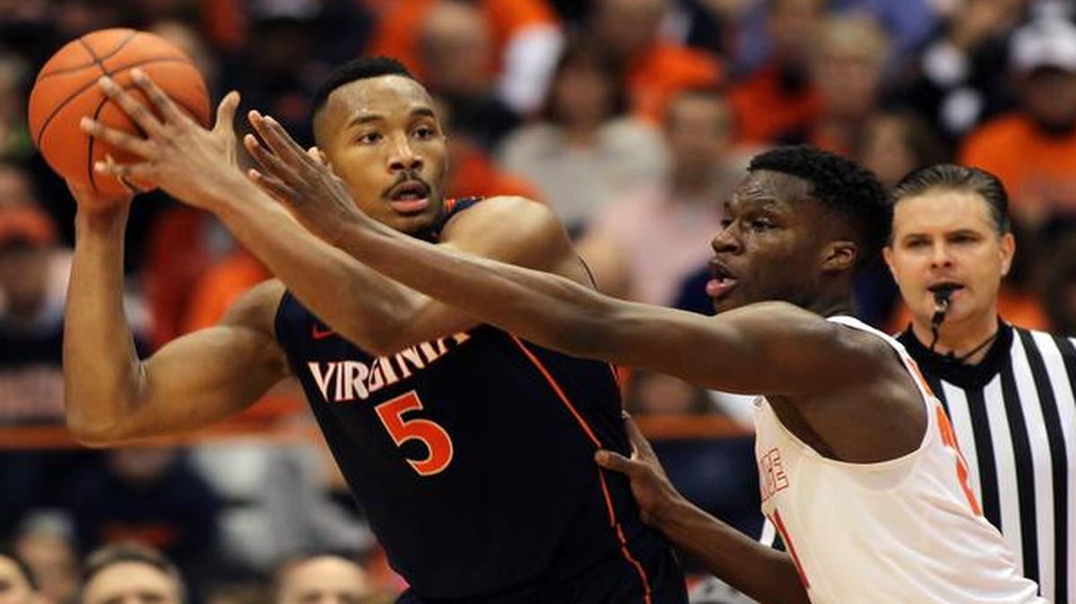 
Virginia’s Darion Atkins, left, looks to pass the ball against Syracuse’s Tyler Roberson on March 2. The Cavaliers have posted back-to-back 16-2 conference records and enter this week’s ACC tournament as the No. 1 seed.
