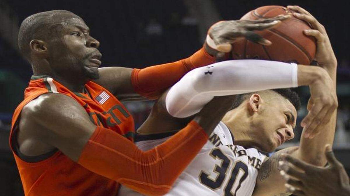
Miami’s Tonye Jekiri (23) gets tangled with Notre Dame’s Zach Auguste (30) as they battle for a rebound in the second half during the quarterfinals of the Atlantic Coast Conference Basketball Tournament at the Greensboro Coliseum.
