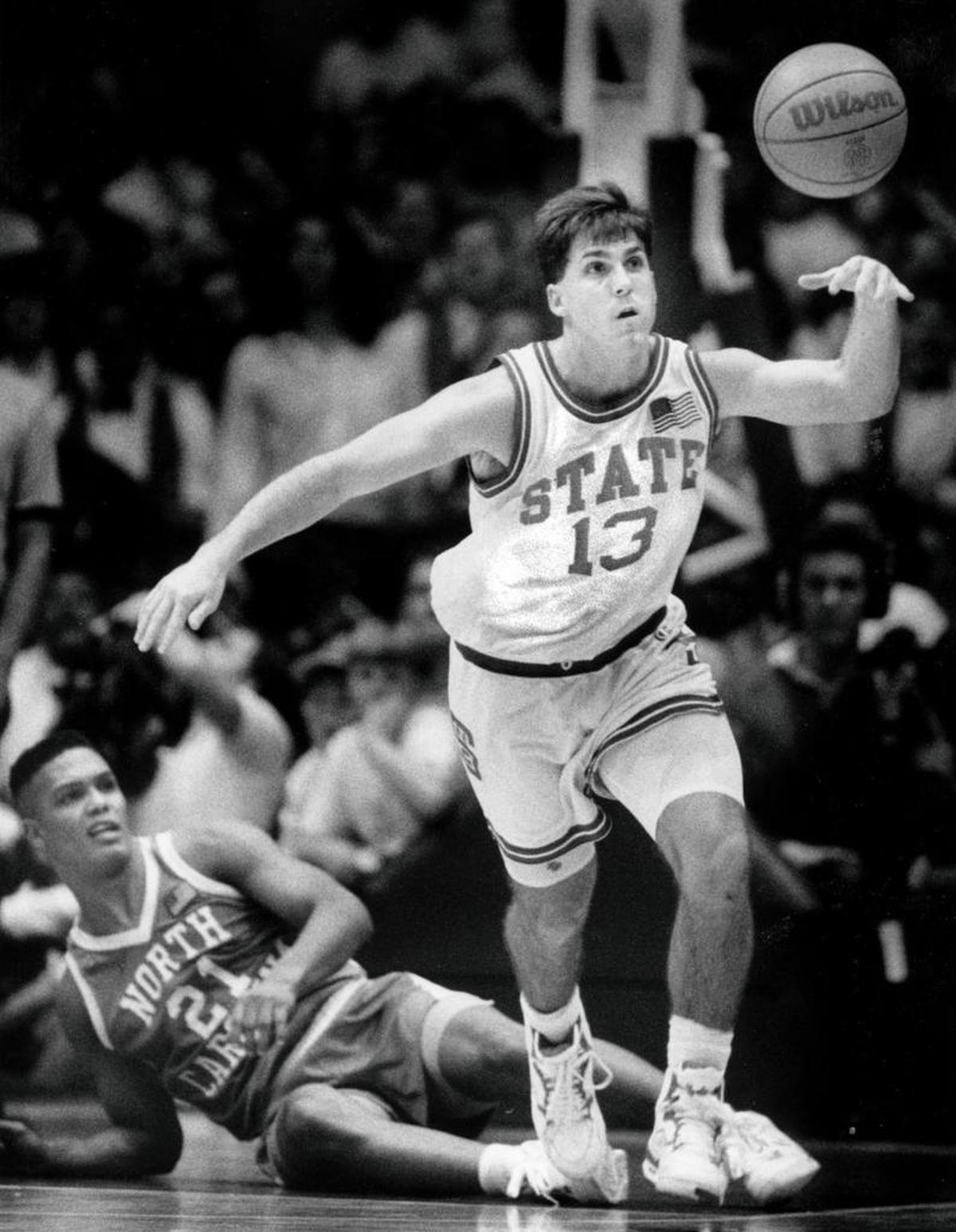 In a 1991 photo, N.C. State point guard Chris Corchiani (13) chases the ball after making steal from UNC point guard King Rice.