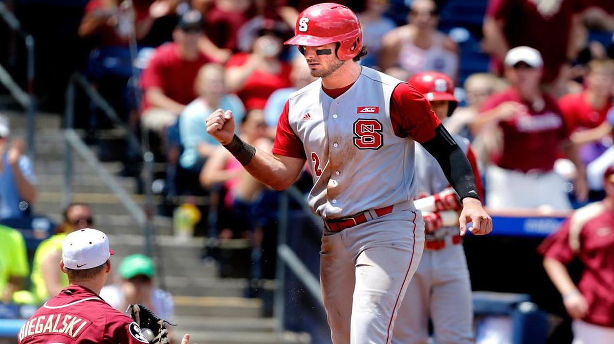 
N.C. State's Bubby Riley (2) celebrates after sliding safe at home on a wild pitch in the fourth inning during Florida State's 6-2 victory over N.C. State in the ACC Baseball Championship at the Durham Bulls Athletic Park in Durham, N.C., Sunday, May 24, 2015.
