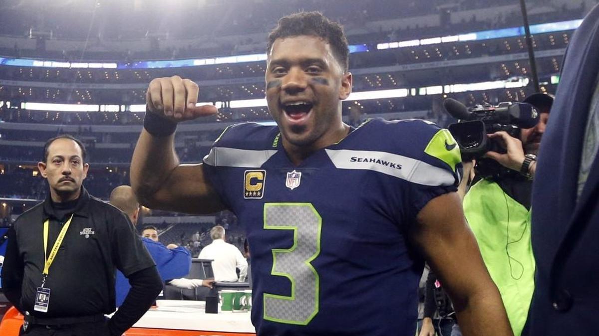 Seattle Seahawks' Russell Wilson (3) cheers as he walks off the field after their NFL football game against the Dallas Cowboys on Sunday, Dec. 24, 2017, in Arlington, Texas. (AP Photo/Michael Ainsworth)