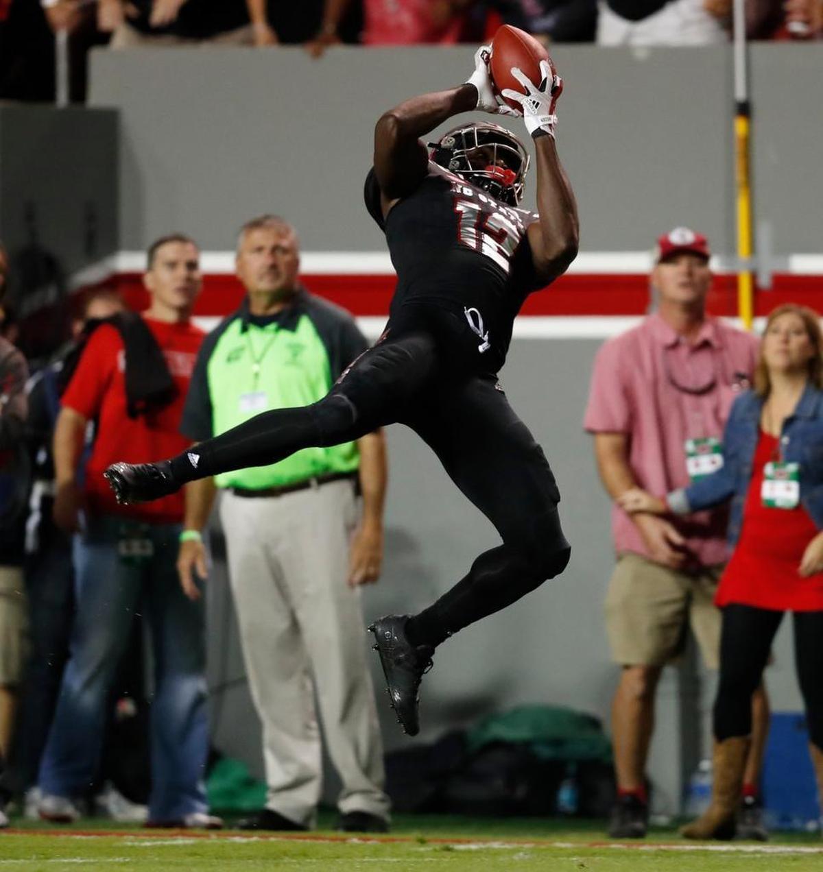 N.C. State’s Stephen Louis (12) makes a 39-yard reception during the first half of the Wolfpack’s victory over Louisville at Carter-Finley Stadium Thursday.