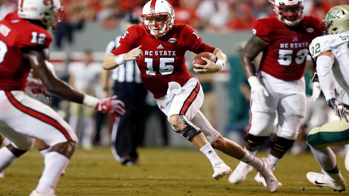 N.C. State quarterback Ryan Finley scrambles for yards during the first half against William & Mary at Carter-Finley Stadium in Raleigh.