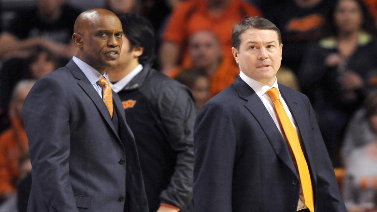 Oklahoma State associate head coach Butch Pierre, left, and head coach Travis Ford look over their team during a timeout in the second half of an NCAA college basketball game against TCU in Stillwater, Okla., Saturday, Jan. 2, 2016.