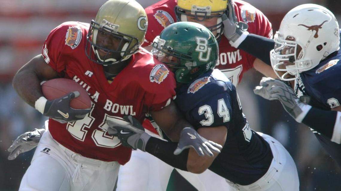East running back P.J Daniels (45), of Georgia Tech, runs for yardage against West’s Colin Allred (34), of Baylor, during the Hula Bowl in Honolulu on Jan. 21, 2006.