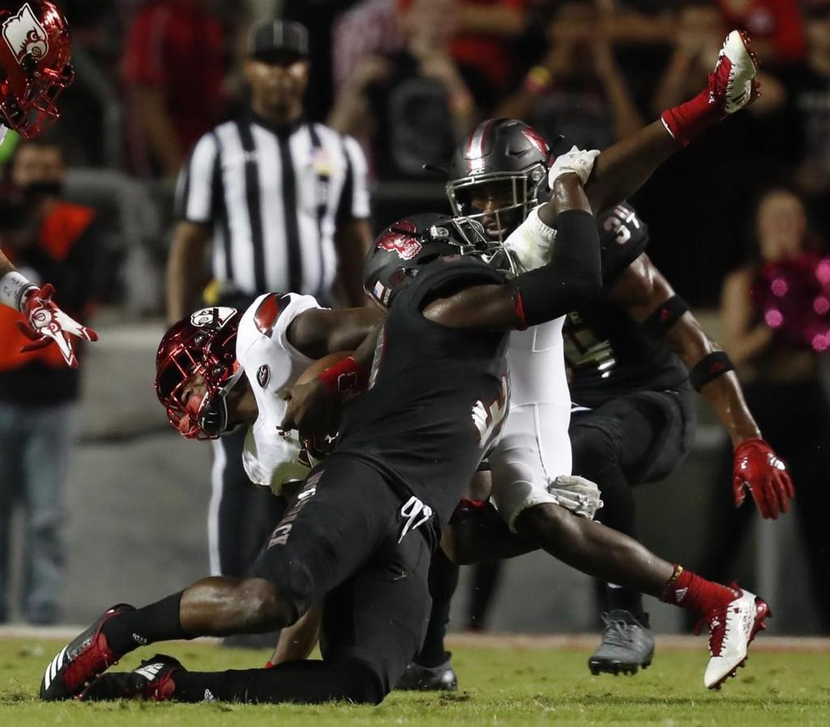 N.C. State safety Jarius Morehead (31) tackles Louisville quarterback Lamar Jackson (8) during the first half of N.C. State’s game against Louisville at Carter-Finley Stadium in Raleigh, NC, Thursday, Oct. 5, 2017.