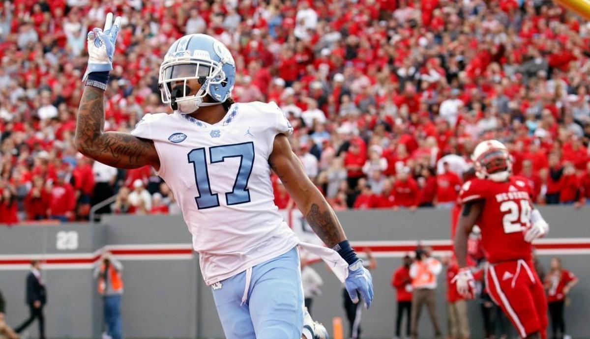UNC's Anthony Ratliff-Williams (17) celebrates a TD in front of N.C. State's Nakia Robinson Jr. (24) during the first quarter.