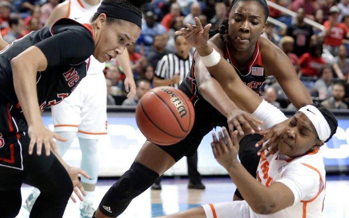 Syracuse's Taylor Ford, right, battles with N.C. State’s Chelsea Nelson, back, and Miah Spencer, left, for a loose ball during the first half of their game in the Atlantic Coast Conference tournament in Greensboro, N.C., Friday, March 4, 2016.