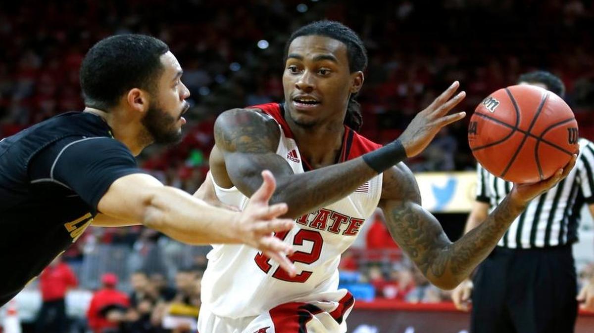N.C. State's Cat Barber passes around Cal State Los Angeles’ Bobby Miles during an exhibition game Nov. 8.